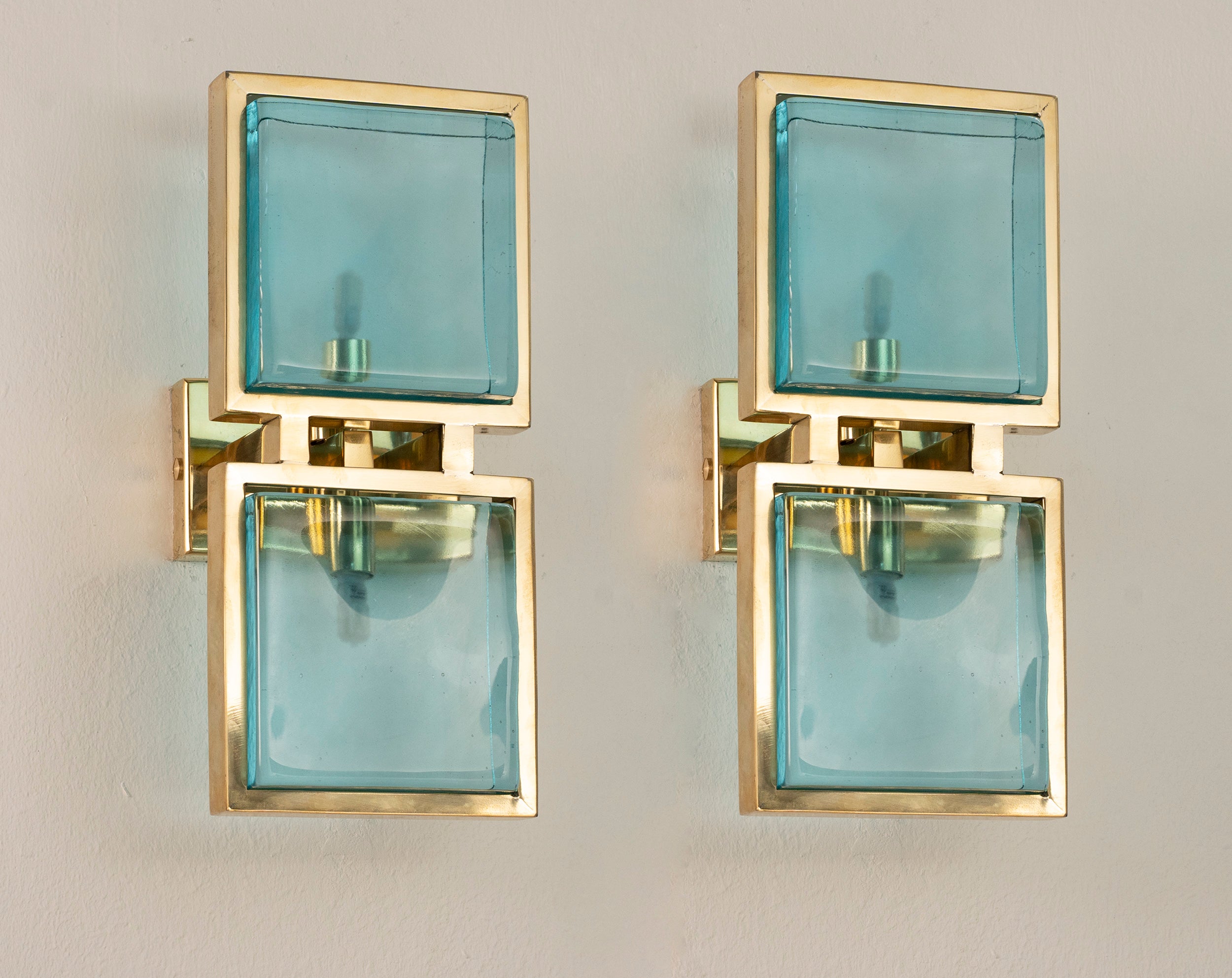 Set of 2 SoloCoseBelle wall sconces with Murano glass bricks and brass frames, designed as elegant accent lamps.