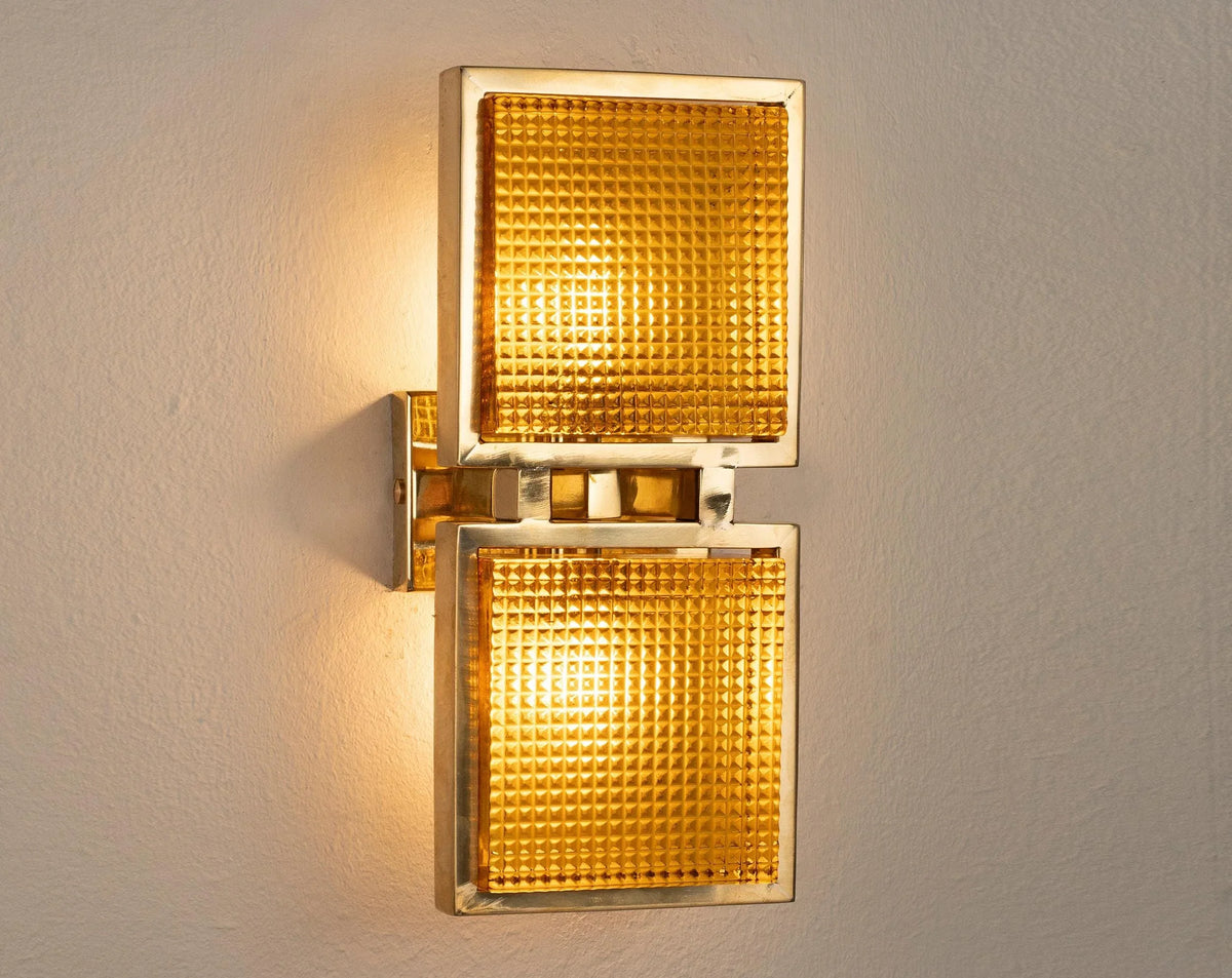 Single amber Murano glass brick wall sconce lit, warm light through the textured glass blocks