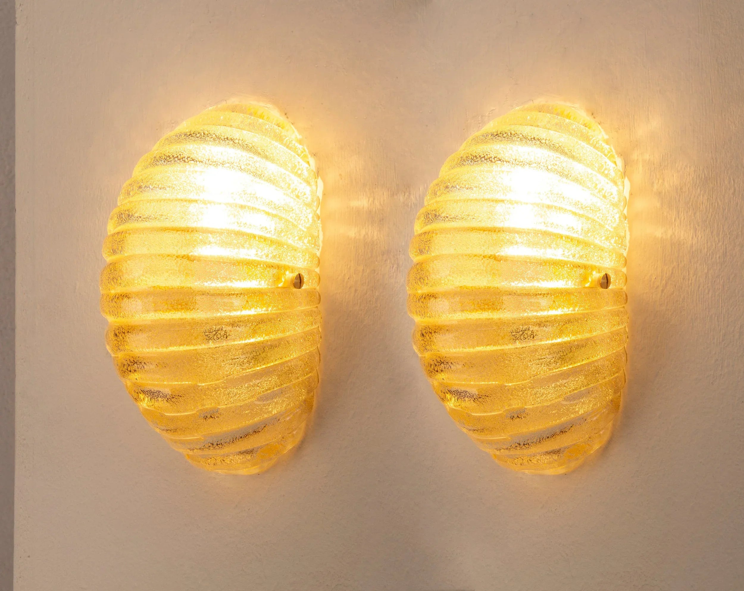 Amber Murano glass shell wall sconce — illuminated pair