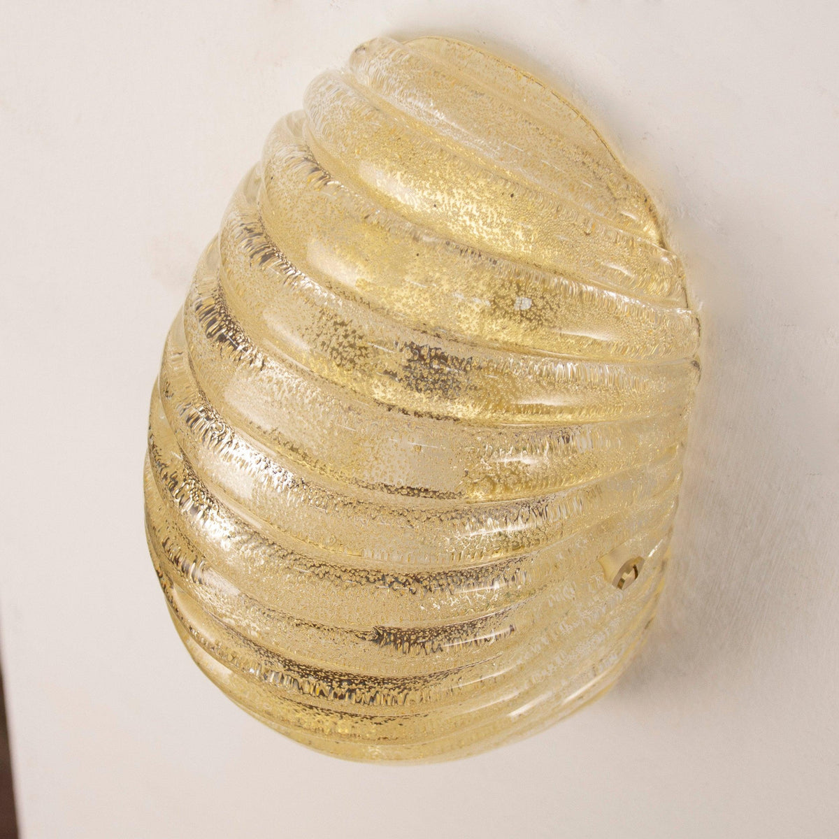 Amber Murano glass shell wall sconce — unlit angled view