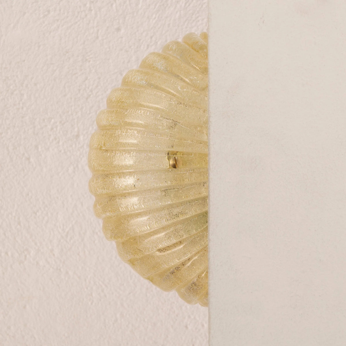 Amber Murano glass shell wall sconce — unlit side view