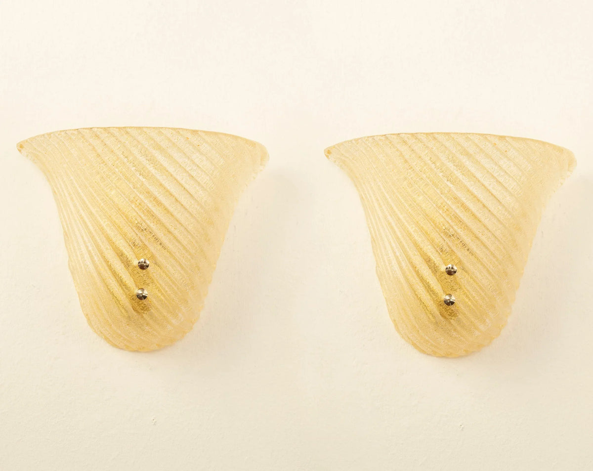 Amber ribbed Murano glass wall sconce — pair of sconces illuminated