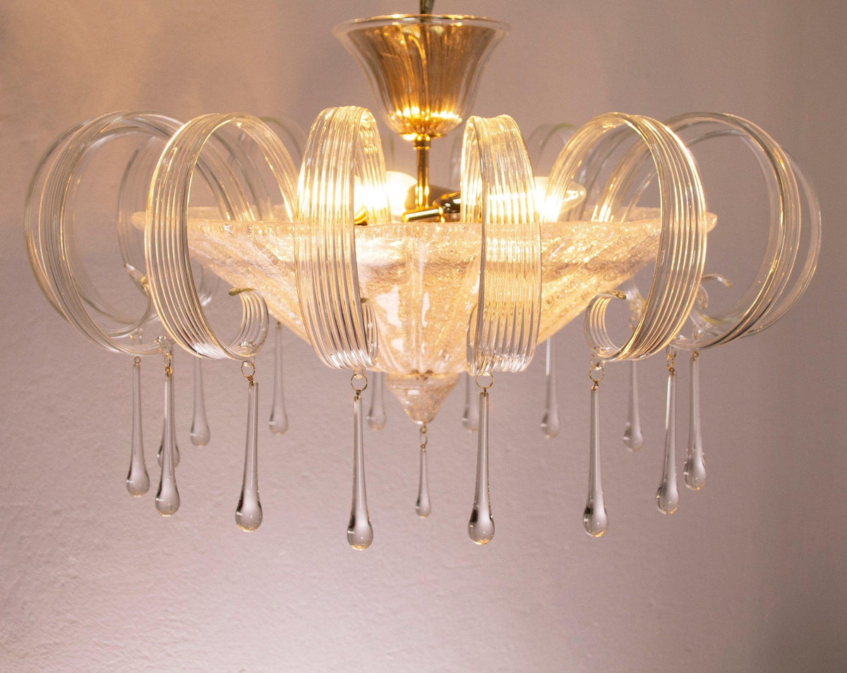 Clear Murano glass chandelier with leaves and drops — illuminated front view