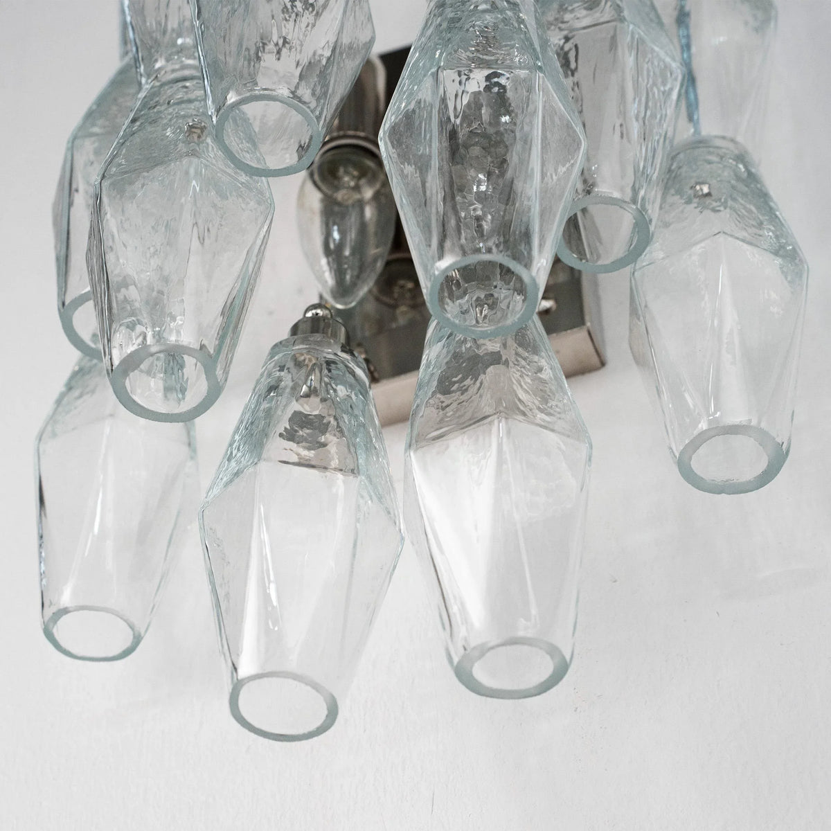 Clear Murano glass Poliedri wall sconce seen from below, showing the bulb holders and open glass ends
