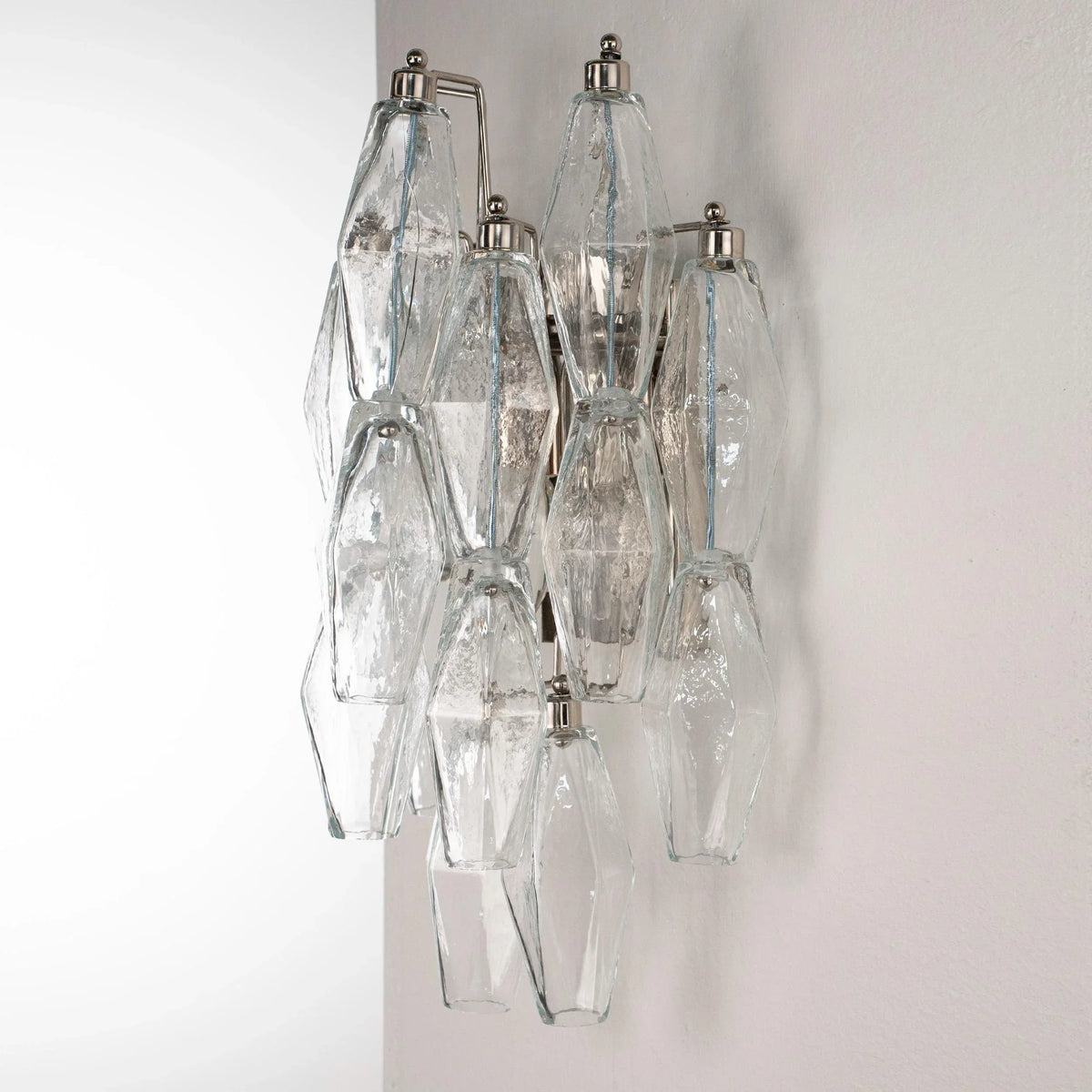 Clear Murano glass Poliedri wall sconce, unlit, side view on a white wall