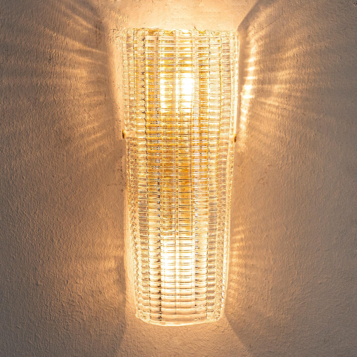 Clear textured Murano glass wall sconce, lit, front view