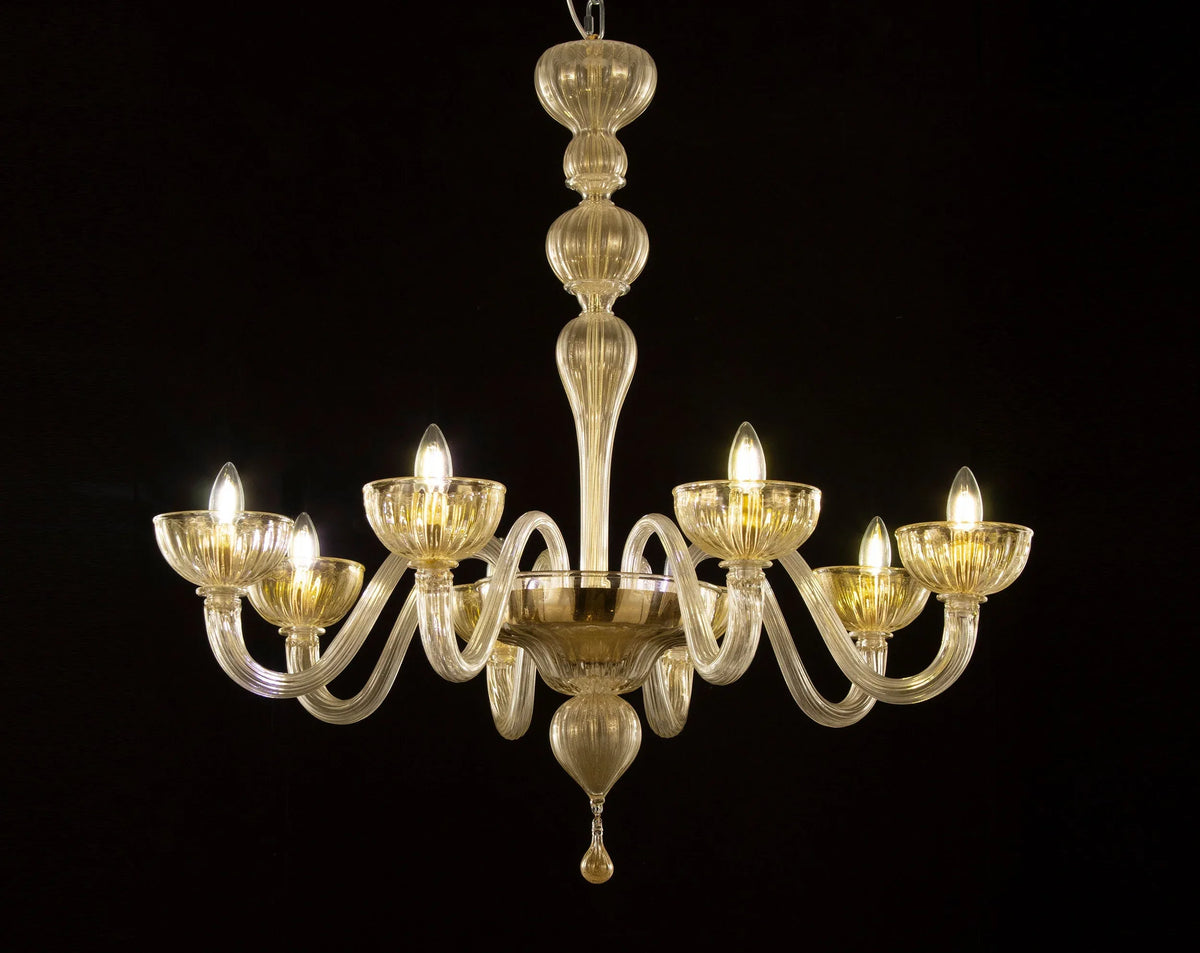 Gold-toned Murano glass eight-arm chandelier — illuminated front view against black background
