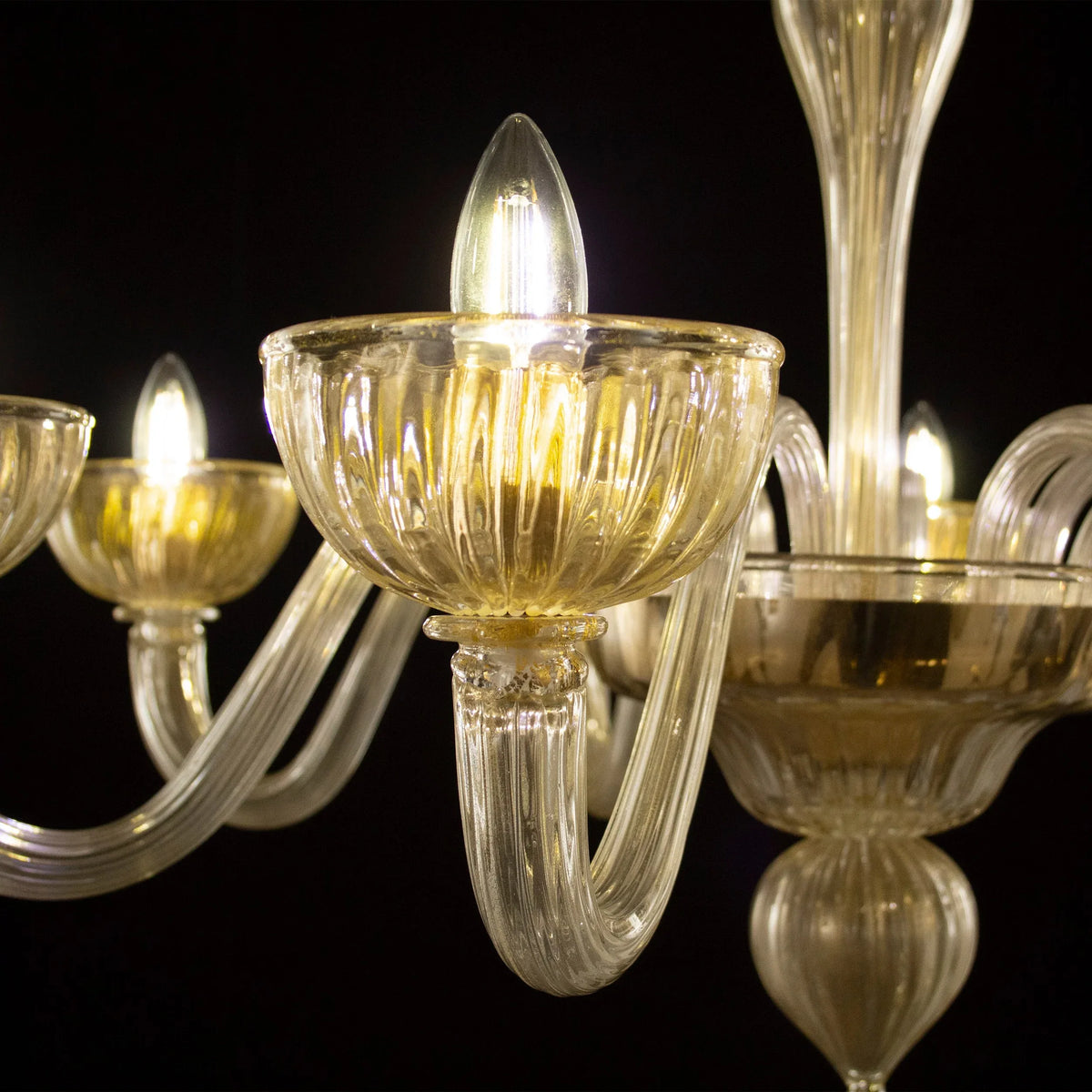 Gold-toned Murano glass eight-arm chandelier — illuminated glass arm and lamp cup