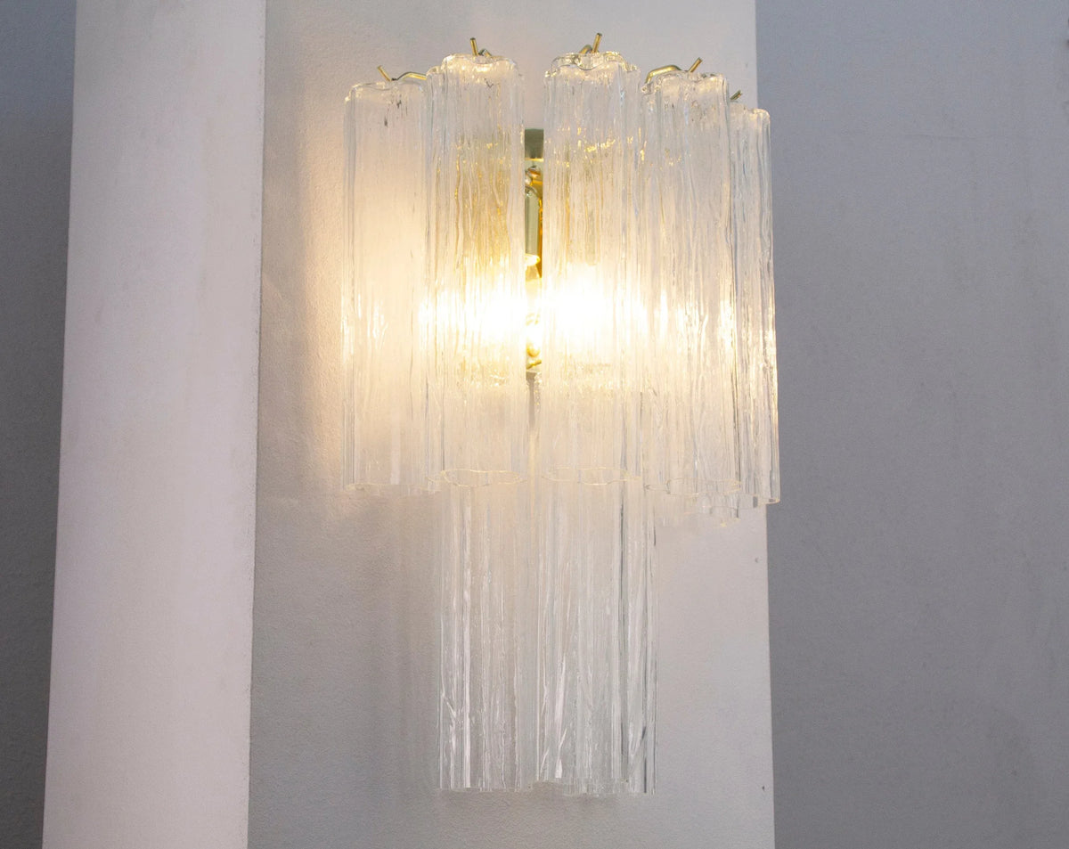 Large clear Tronchi Murano glass wall sconce — illuminated full view