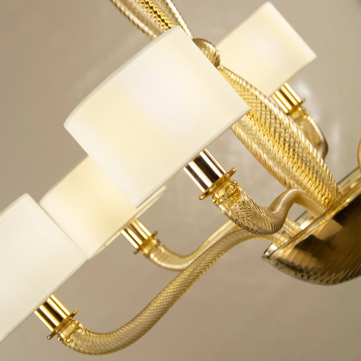 Murano glass chandelier with ivory lampshades — angled view of shades and glass arms