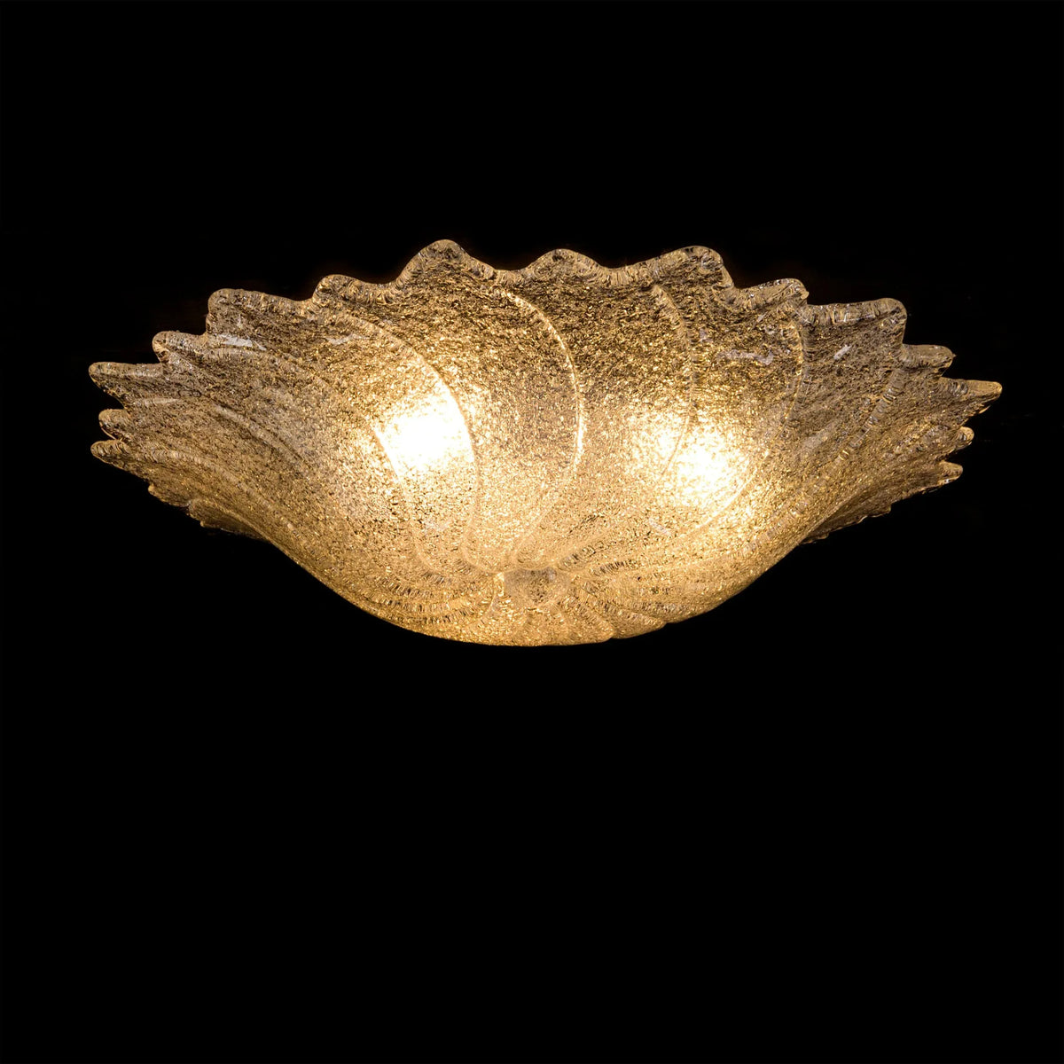 Frosted Murano glass flush ceiling lamp, lit, side view on a black background