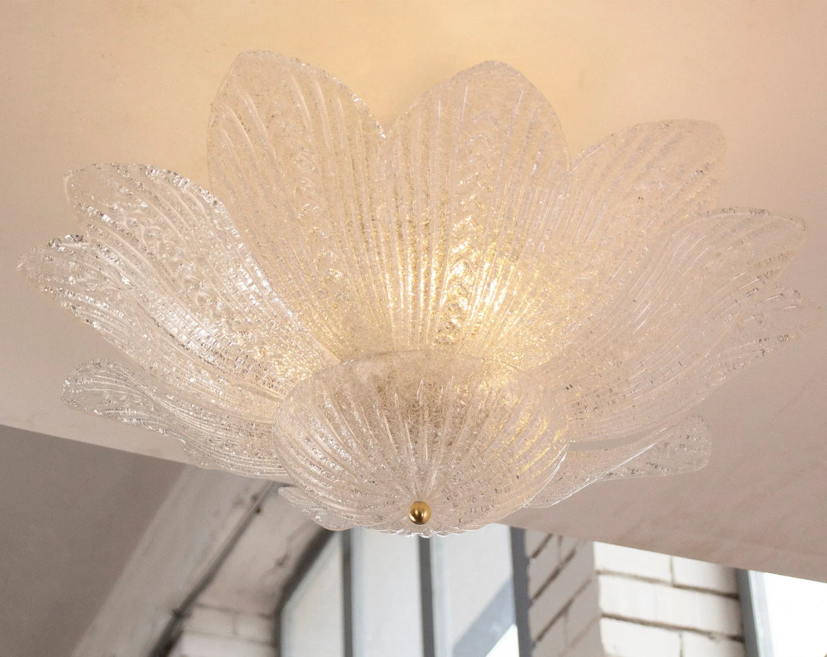 Clear Murano glass leaf ceiling lamp with graniglia texture, lit, seen from below in a room