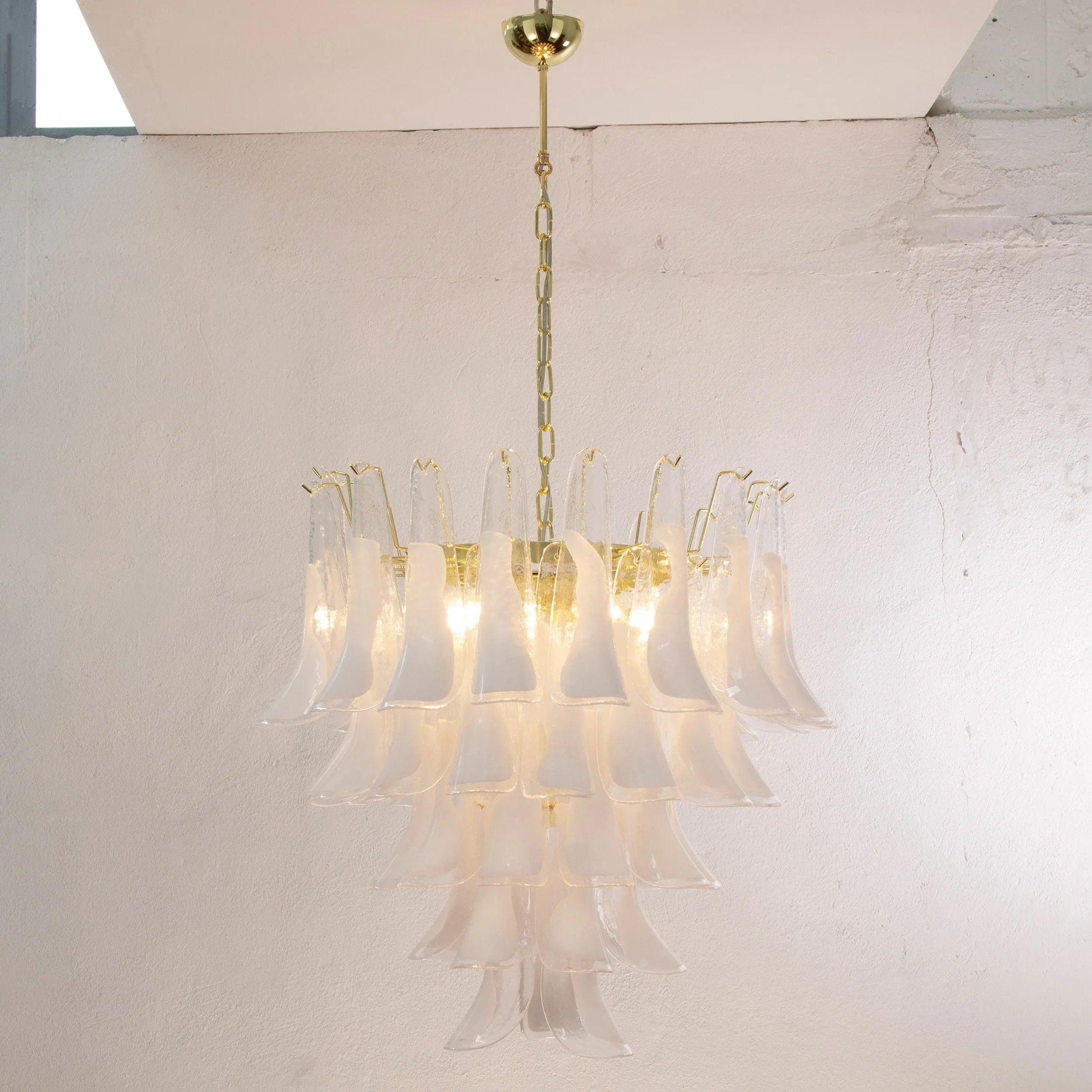 Petali Murano glass chandelier — illuminated with five tiers of white glass petals
