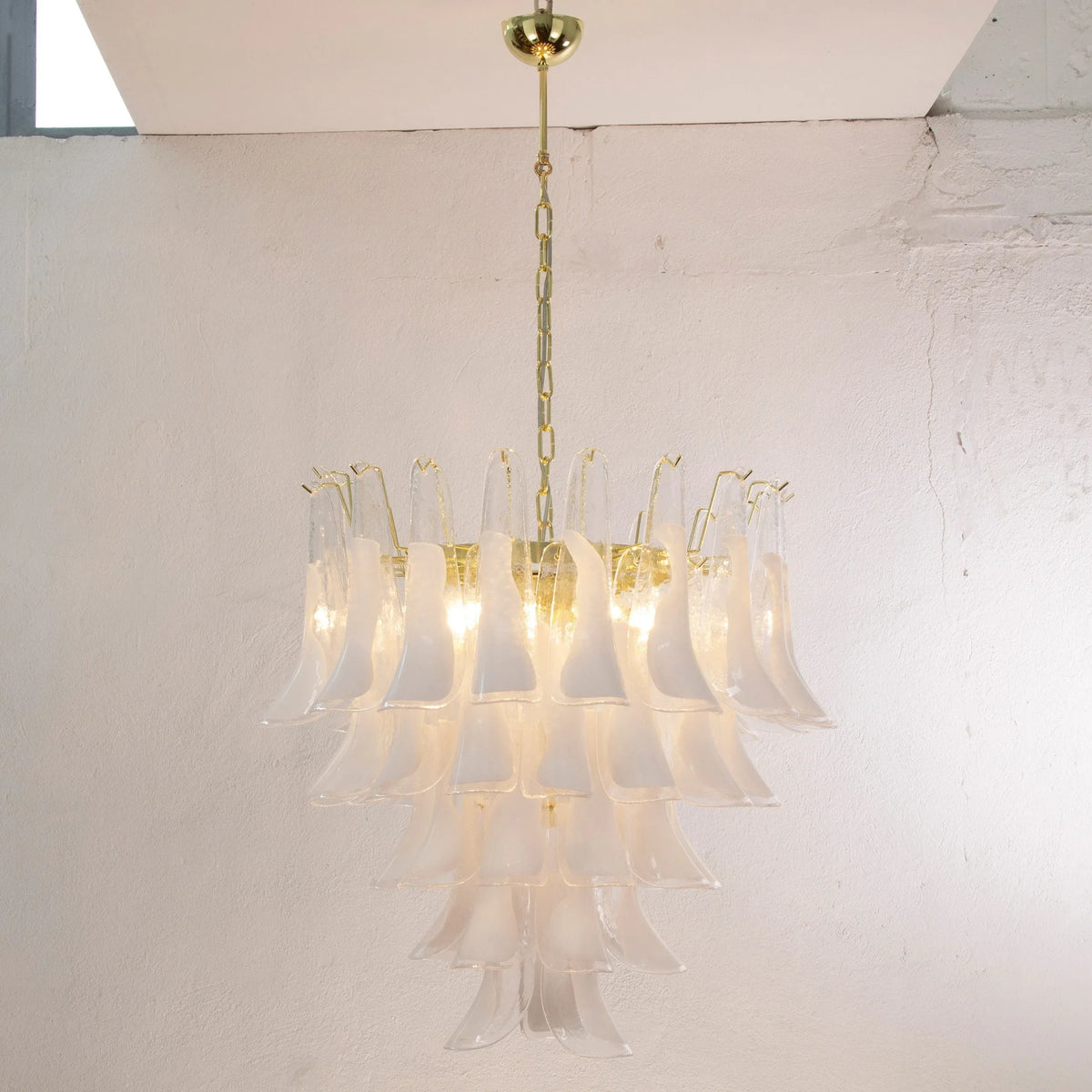 Petali Murano glass chandelier — illuminated with five tiers of white glass petals