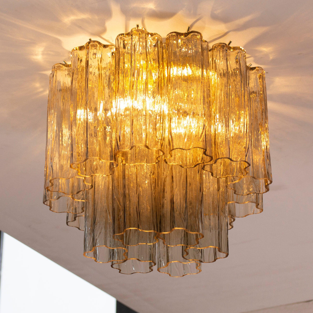 Tronchi Murano glass ceiling light illuminated, angled view