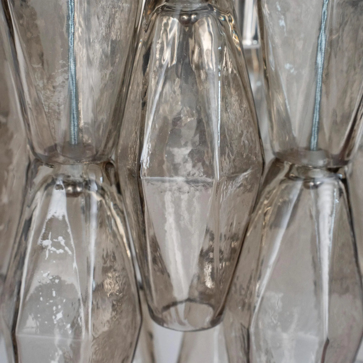 Macro close-up of the smoky Poliedri Murano glass, showing bubbles and texture of the vintage glass
