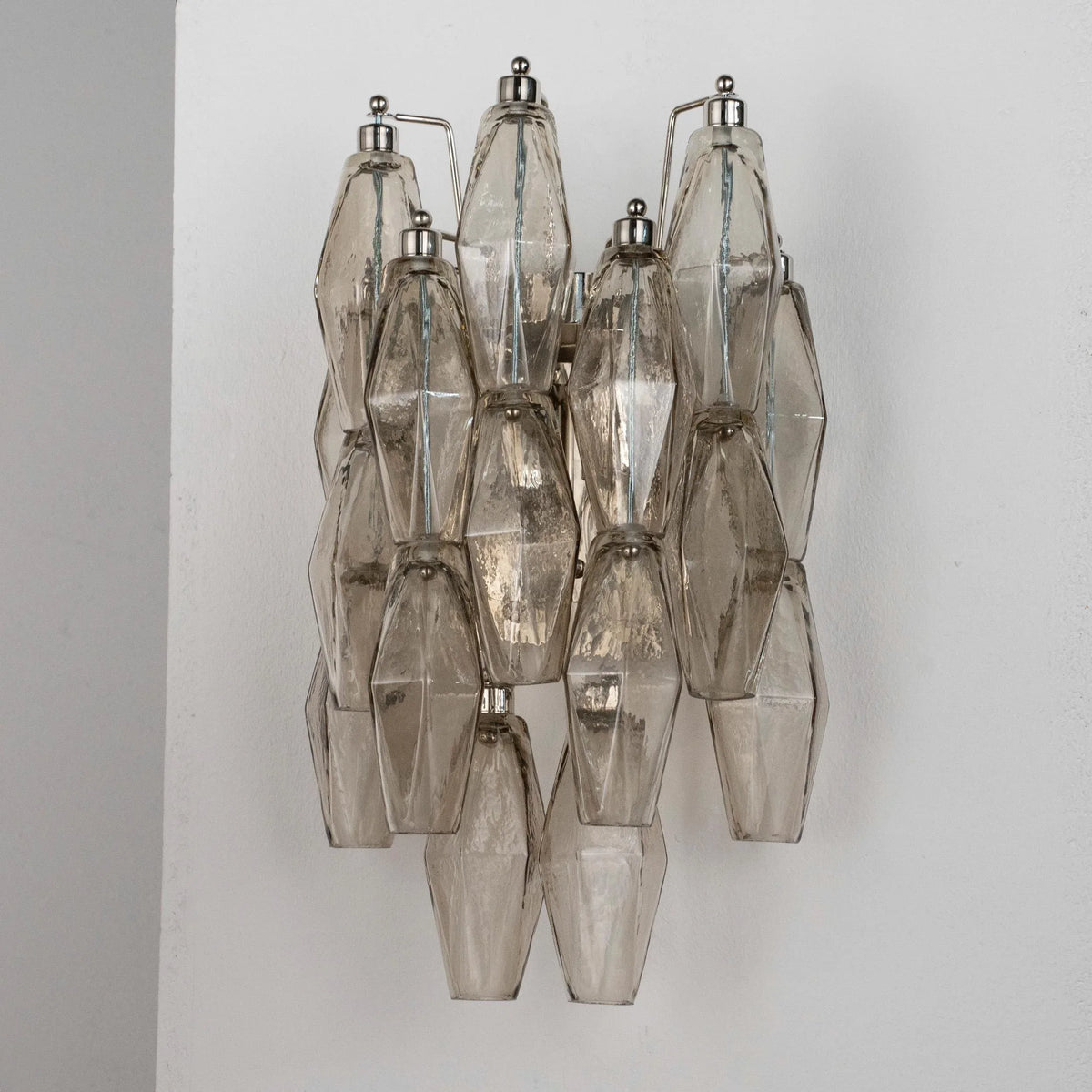 Vintage smoky Poliedri Murano glass wall sconce with chrome frame, unlit on white wall
